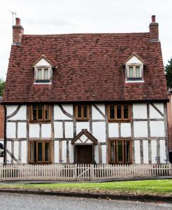 an old house with a red roof at One Abbey Lane in Southam