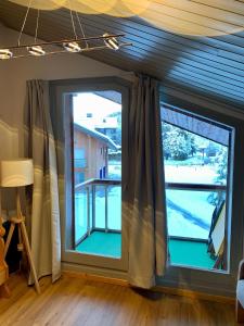 two windows in a room with a view of a yard at LES COMBETTES in Les Contamines-Montjoie