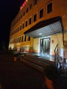 a building with a staircase leading to the entrance to a building at Lux Resort in Kraśnik