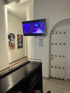 a room with a flat screen tv on a wall at Casa Noir Cartagena in Cartagena de Indias