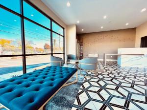 a lobby with a blue couch and a large window at Ramada by Wyndham Modesto Yosemite Area in Modesto +48 photos