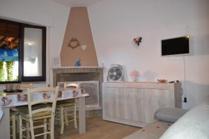 a living room with a table and a fireplace at TERESA HOLIDAY in Sarroch