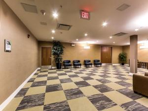 an empty lobby with chairs and a checkerboard floor at Radisson Hotel Edmonton Airport in Leduc