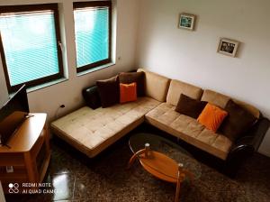 a living room with a couch and a table at OHRID LOFT : The Den in Ohrid