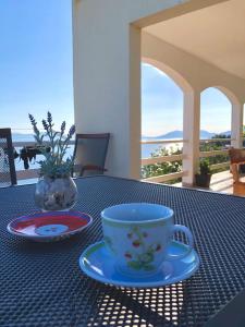 a table with a coffee cup and a plate on it at Holiday home Ivo in Prigradica