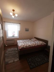 a small bedroom with a bed and a window at Privat Teo Podtureň in Liptovský Mikuláš
