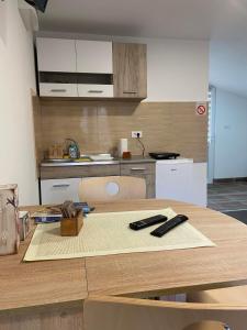 a kitchen with a table with two remote controls on it at Vila Nika in Crni Vrh