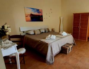 a bedroom with a bed with towels on it at ARAGONESE 73 in Taranto