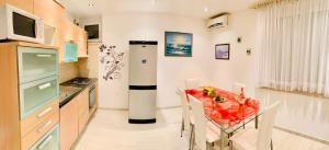 a kitchen with a table and a refrigerator at Apartment Marina Senj in Senj