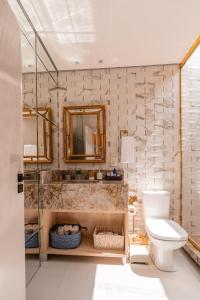a bathroom with a toilet and a mirror at Morada Reino Encantado in São Joaquim +155 photos