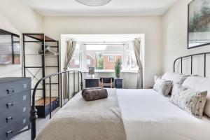 a bedroom with a bed and a desk and a window at Elegant Retreat Nook at Peak District Gateway in Totley