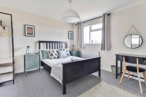 a bedroom with a bed and a table and a chair at Elegant Retreat Nook at Peak District Gateway in Totley