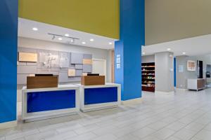 a store lobby with blue walls and white tile floors at Holiday Inn Express Hotel & Suites Lake Placid, an IHG Hotel in Lake Placid