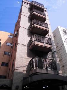 a tall building with balconies on the side of it at Park Inn in Osaka