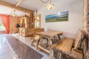 a dining room with a wooden table and chairs at Góralski Dworek in Czarna Góra