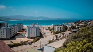 a view of a city with the ocean in the background at Playa Los Molles , lindo lugar , cómoda cabaña, ideal para descansar , los esperamos 24 7 in Los Molles