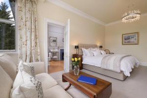 a bedroom with a bed and a living room at Lys-Na-Greyne Country House in Aboyne