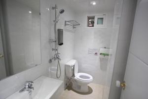 a bathroom with a shower and a toilet and a sink at Namsan Guesthouse in Seoul +53 photos