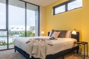 Ένα ή περισσότερα κρεβάτια σε δωμάτιο στο KULA Apartments Parramatta