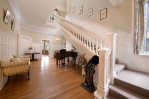 a living room with a staircase and a table at Lys-Na-Greyne in Aboyne