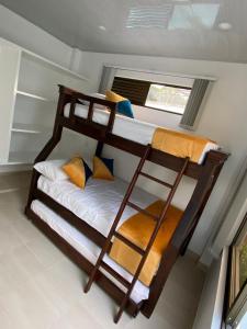 two bunk beds in a room with a window at Natural View in Melgar