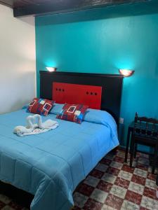 Postel nebo postele na pokoji v ubytování Hotel Clasico Colonial