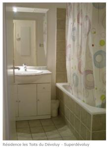La salle de bains est pourvue d'un lavabo et d'un rideau de douche. dans l'établissement " B17 " T2-4p de standing au pied des pistes de Superdévoluy - "résidence Les Toits du Dévoluy" - Vue Magnifique -, à Saint-Étienne-en-Dévoluy
