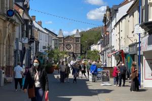a group of people walking down a city street at The Crest Hillside Retreat With Hot Tub in Abertillery
