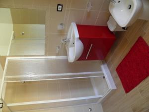 a bathroom with a sink and a toilet and a mirror at B&B Mare & luna in San Sostene