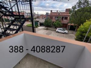 a clock on the side of a building with a street at Habitación con baño privado en edificio 1er piso in San Salvador de Jujuy