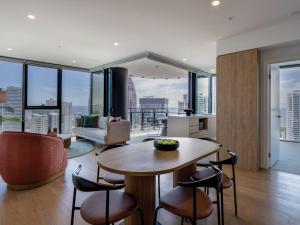 a kitchen and living room with a table and chairs at The Star Residences - Gold Coast in Gold Coast