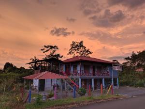 a building with a playground in front of it at Cabinas Cascada Rio Celeste in Bijagua