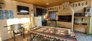a kitchen with a table and a stove and a refrigerator at Recanto Dumar in Peruíbe