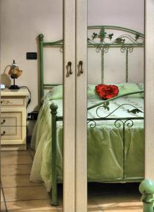 a bedroom with a bed with a red rose on it at Il Centro Storico in Posta Fibreno