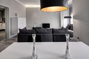 a living room with a table and a couch at Habitat Apartments Paseo de Gracia in Barcelona