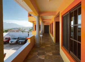 a balcony of a building with cars parked in a parking lot at HOTEL SAN JUDAS in San Pablo Villa de Mitla