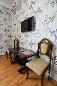 a dining room with a table and two chairs at Elit Hotel in Derbent