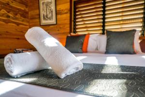 two rolls of towels on a bed in a room at Wildwood in Cape Tribulation