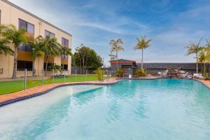 a large swimming pool in front of a building at Nightelier Mermaid Waters in Gold Coast