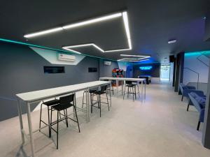 a conference room with tables and chairs and blue lighting at GG Hotel Bandar Sunway in Petaling Jaya