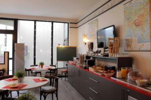 a restaurant with two tables and a counter with food at Best Western Crequi Lyon Part Dieu in Lyon