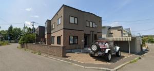 a jeep parked in front of a house at Maion de Ieyasu in Sapporo