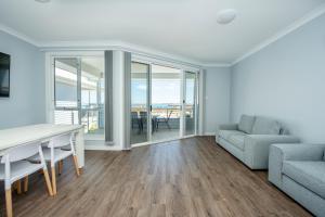 a living room filled with furniture and a window at Wallaroo Beachfront Tourist Park in Wallaroo