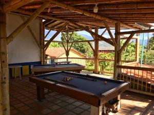two pool tables on a patio with awning at Finca Hotel La Esmeralda Casa 2 in Calarcá