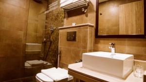 a bathroom with a toilet and a sink and a shower at Aabas Pokhara by Barahi Hospitality in Pokhara