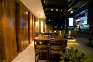 a restaurant with a table and chairs in a room at Aabas Pokhara by Barahi Hospitality in Pokhara