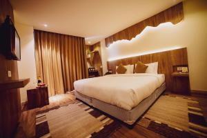 a bedroom with a large bed in a room at Aabas Pokhara by Barahi Hospitality in Pokhara