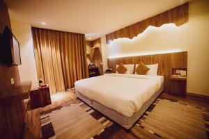 a bedroom with a large bed in a hotel room at Aabas Pokhara by Barahi Hospitality in Pokhara