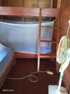 a broom and a fan in a room with a boat at Nyang Ebay Surf Camp siberut front E-Bay,Beng-Bengs,Pitstops,Bank Vaults,Nipussi in Masokut