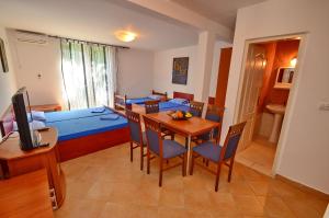 a room with a dining table and a living room at Apartments Scorpio in Kotor